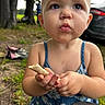 toddler, child, outdoor, food, snack, face, expression, blue_dress, grass, trees, car, hands, pout, curious, person, summer, nature, closeup, cute, daylight