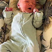 Huntleigh joined the competition — help win amazing prizes! newborn, baby, infant, onesie, sleeping, cozy, cushion, floral_pattern, fabric, soft, cute, child, indoors, resting, peaceful, small_hands, lying_down, pink_socks, face, comfort
