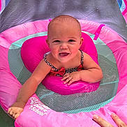 Huntleigh is registered to the contest to win money with this photo: baby, child, swimming, float, pink, water, smiling, happy, infant, summer, outdoor, playful, person, pool, safety, sunlight, cute, fun, hand, swim_school