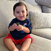 Vincent joined the competition — help win amazing prizes! toddler, child, smiling, toy, car, sitting, couch, indoor, clothing, shorts, shirt, happy, face, feet, hands, hair, home, pillow, furniture, play