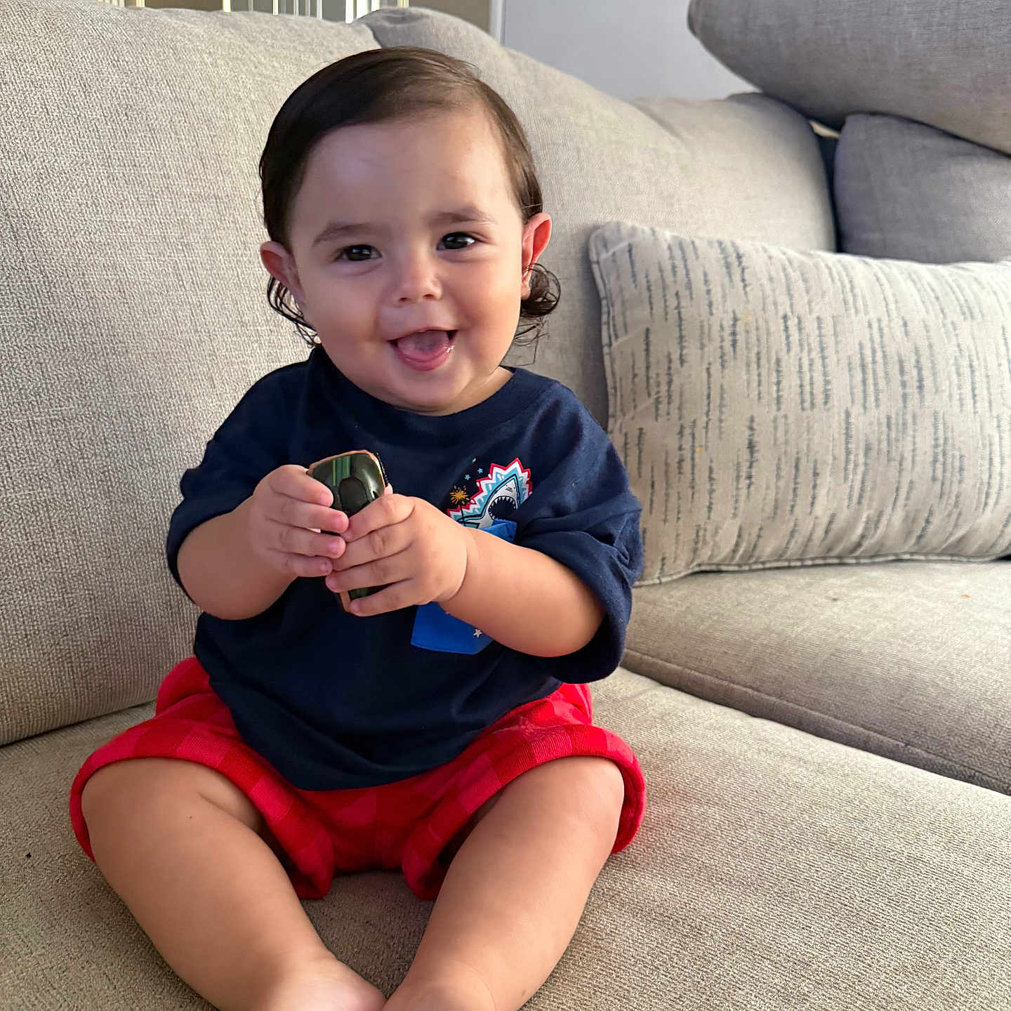 Vincent joined the competition — help win amazing prizes! car, child, clothing, couch, face, feet, furniture, hair, hands, happy, home, indoor, pillow, play, shirt, shorts, sitting, smiling, toddler, toy