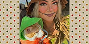 Trouble joined the competition — help win amazing prizes! braid, car, cat, costume, face_paint, green, happy, holding, hoodie, indoor, makeup, orange, person, pet, plaid, portrait, scarecrow, seat, sunlight, window