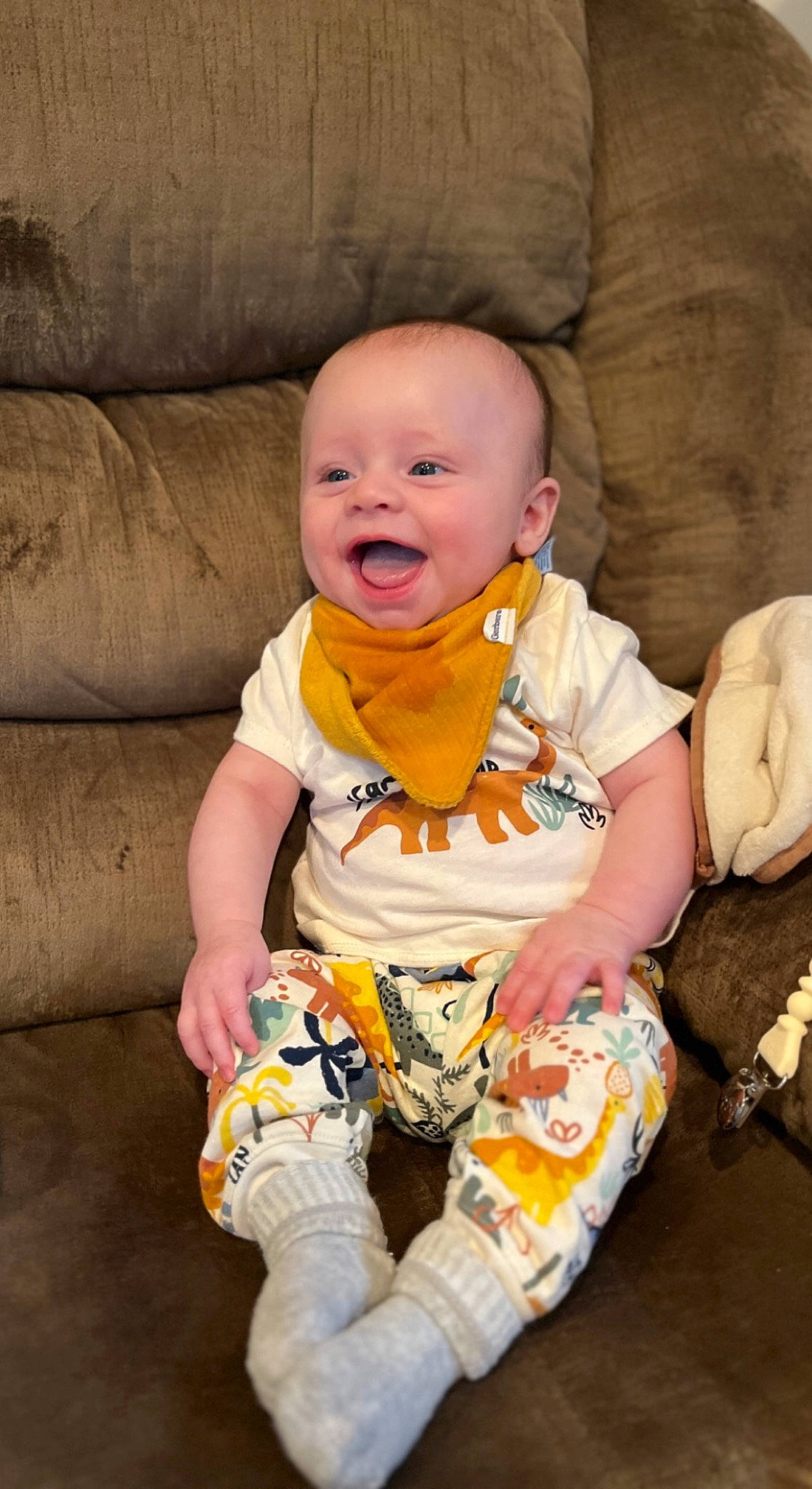 Maverick is registered to the contest to win money with this photo: baby, baby_products, baby_toddler_clothing, cheek, child, comfort, face, fun, happy, pattern, people, person, play, sitting, skin, sleeve, smile, t_shirt, textile, toddler