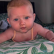 Maizey-May is registered to the contest to win money with this photo: baby, infant, child, face, blue_eyes, skin, hair, blanket, pattern, bed, indoor, portrait, cute, young, lying_down, expression, human, person, soft_lighting, close_up