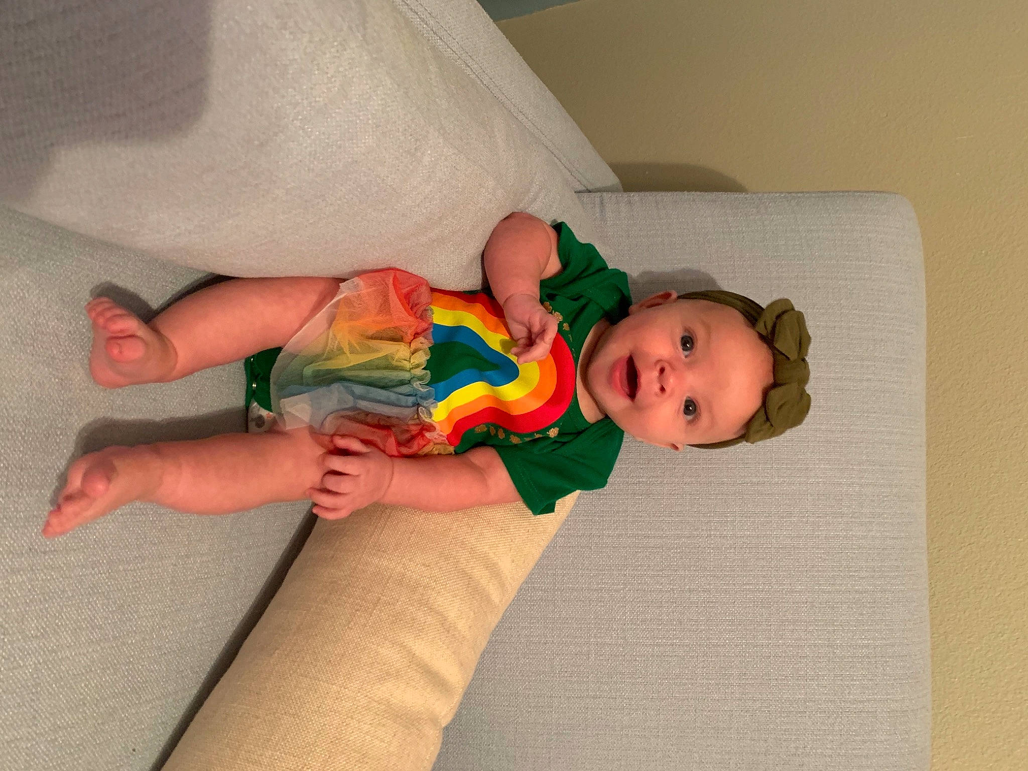 Skylar is registered to the contest to win money with this photo: baby, baby_products, baby_toddler_clothing, child, comfort, finger, flooring, foot, fun, head, human_body, human_leg, knee, linens, pattern, person, play, room, sock, thigh