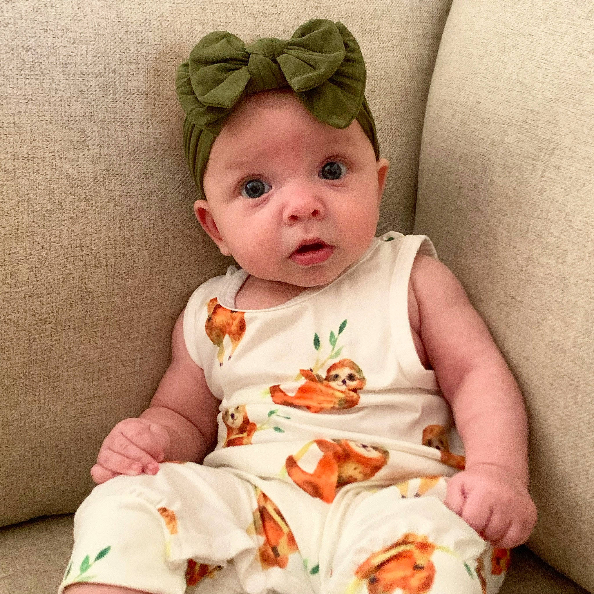 Skylar is registered to the contest to win money with this photo: baby, baby_toddler_clothing, cheek, collar, comfort, dress, eye, face, happy, head, iris, linens, pattern, person, pink, product, skin, sleeve, surprise, t_shirt