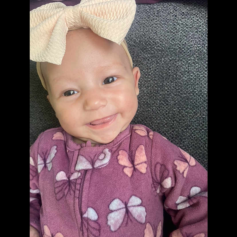 Harlynne is registered to the contest to win money with this photo: baby, babylaughing, bodypart, bonnet, cap, clothing, dress, face, happy, hat, head, hood, laughing, mouth, newborn, person, photography, portrait, shoulder, smile