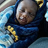 baby, child, smiling, hoodie, blanket, blue, navy_blue, plush, sleepy, face, person, infant, cute, cozy, warm, portrait, indoors, car_seat, wrapped, content