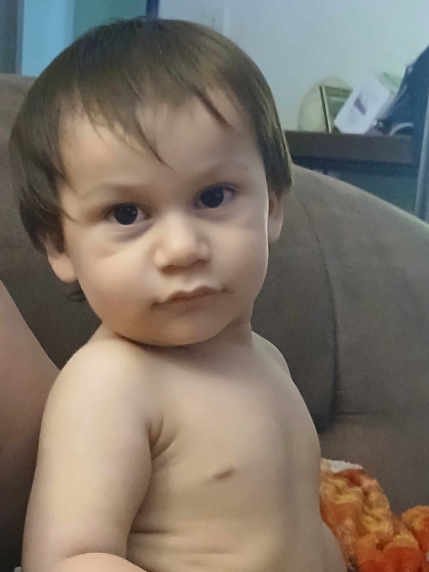 Rey is registered to the contest to win money with this photo: toddler, child, face, hair, eyes, skin, couch, blanket, indoors, portrait, baby, expression, young, person, sitting, furniture, curious, casual, soft_light, candid