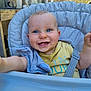 baby, child, blue_eyes, high_chair, smiling, outdoor, seat_belt, gray_cushion, yellow_tshirt, reaching_hand, face, portrait, happy, infant, person, chair, daylight, casual_clothing, wooden_table, plastic_chair