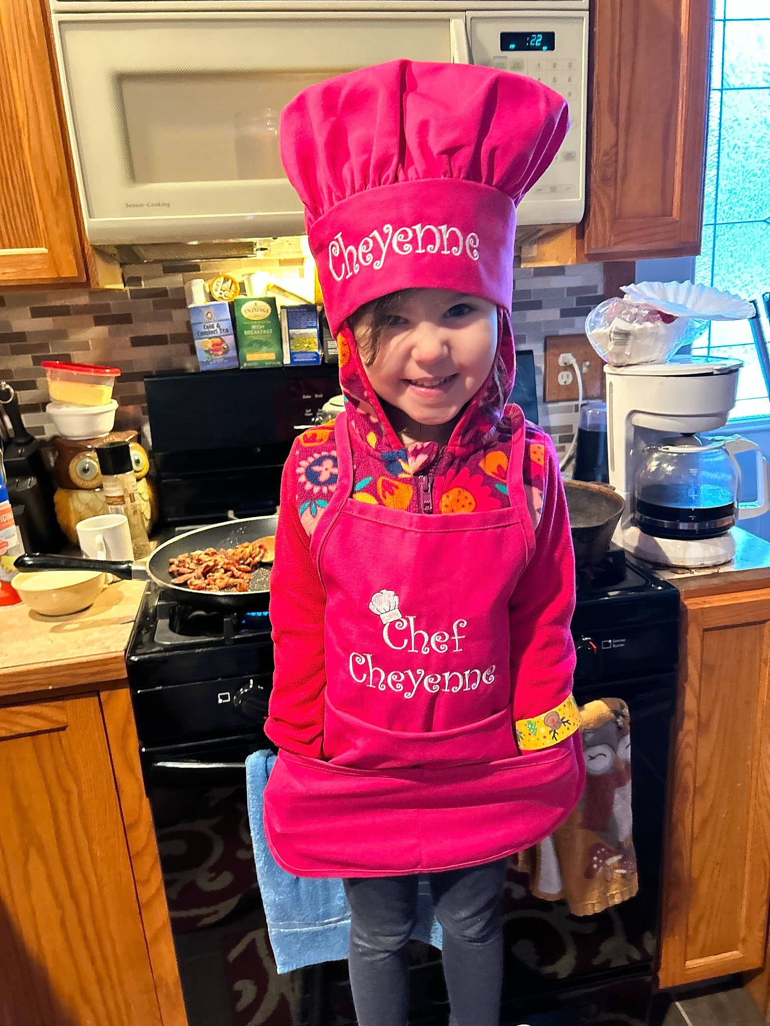 Cheyenne joined the competition — help win amazing prizes! cabinetry, cap, child, cook, cooking, countertop, fun, headwear, home_appliance, kitchen, kitchen_appliance, magenta, person, personal_protective_equipment, pink, room, service, shorts, sleeve, smile