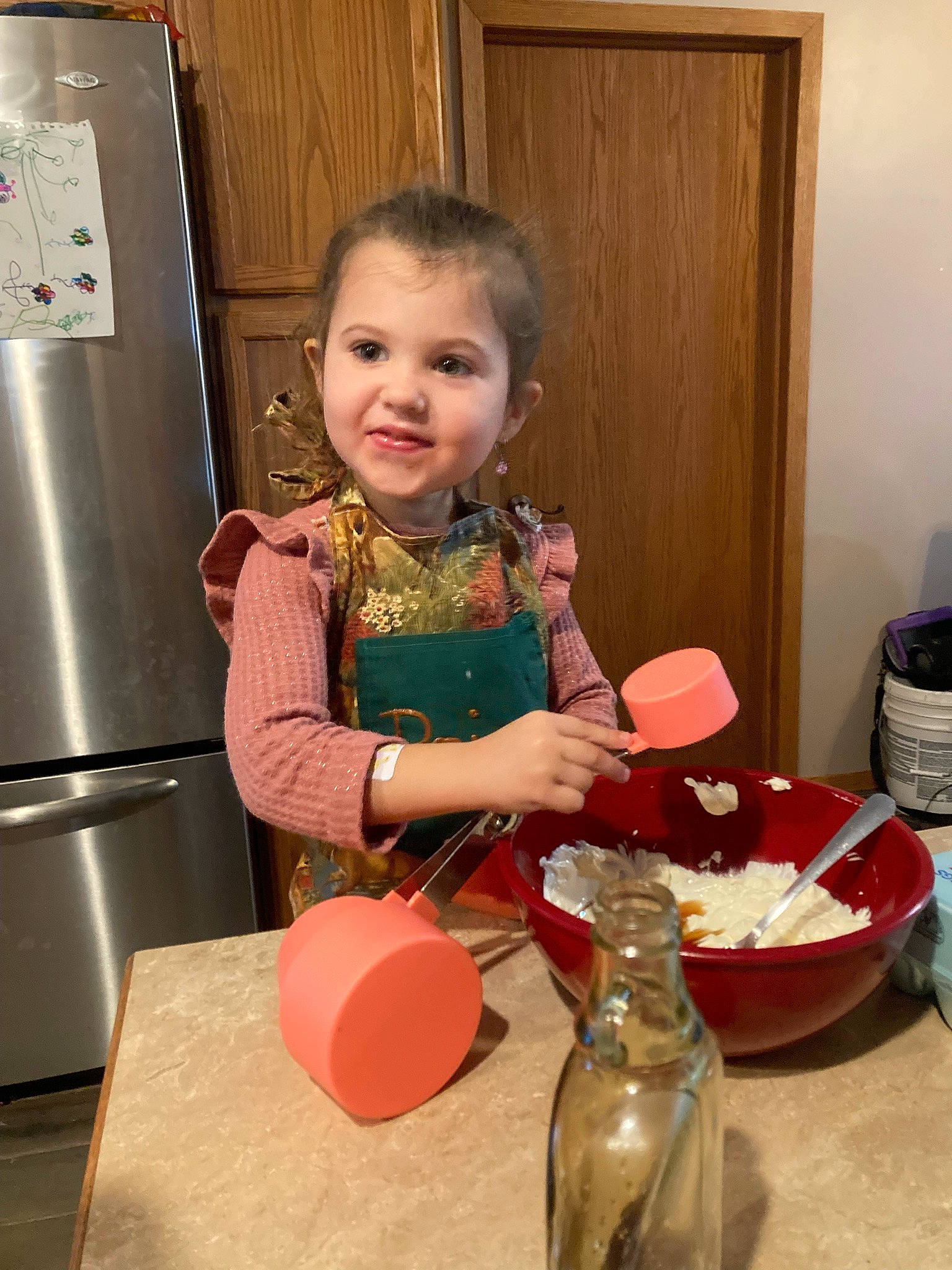 Cheyenne joined the competition — help win amazing prizes! cabinetry, child, cooking, countertop, door, drawer, drinkware, flooring, gas, joy, kitchen, kitchen_appliance, person, plate, refrigerator, room, serveware, smile, standing, table