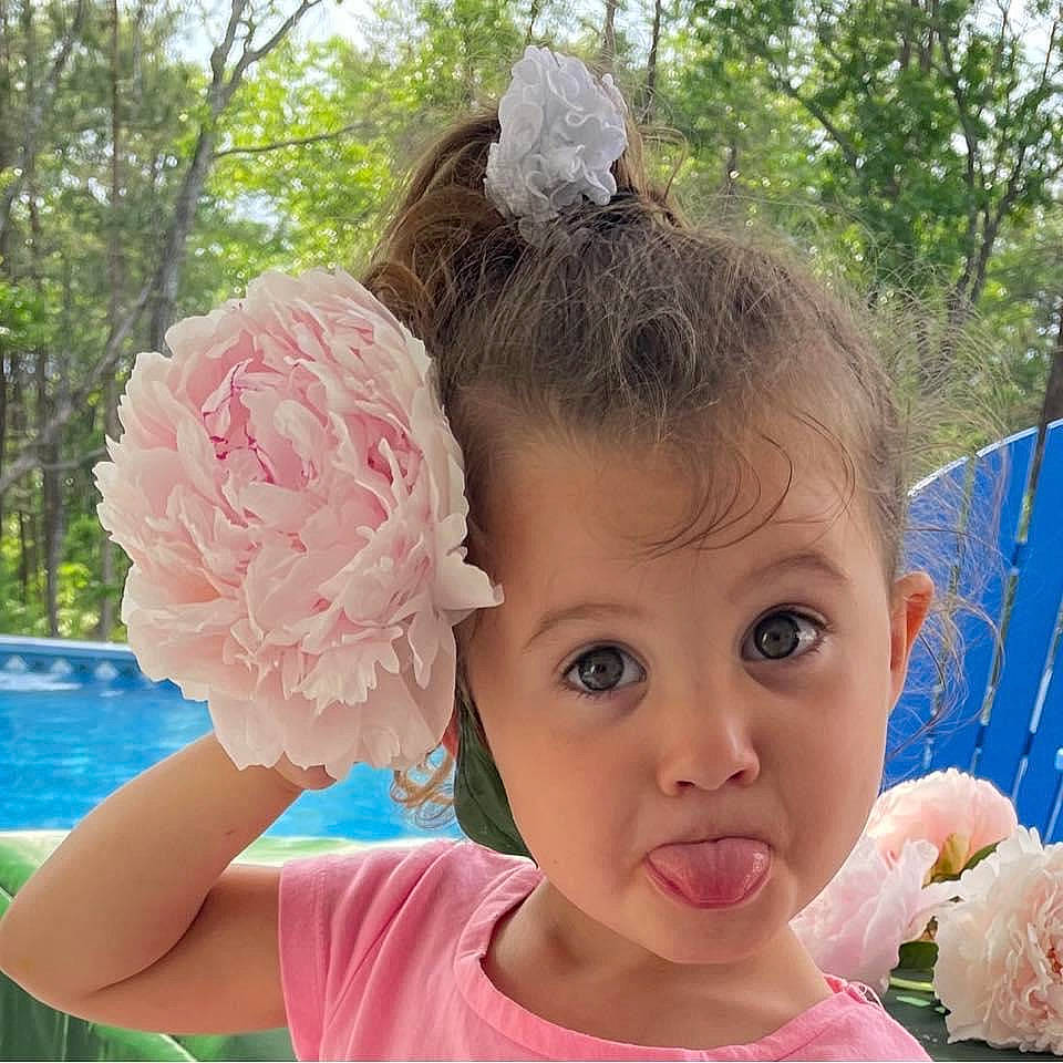 Cheyenne is registered to the contest to win money with this photo: baby, baby_toddler_clothing, child, eyelash, fashion_accessory, flower, fun, grass, hair_accessory, happy, headband, headgear, headpiece, leisure, magenta, person, petal, pink, plant, toddler