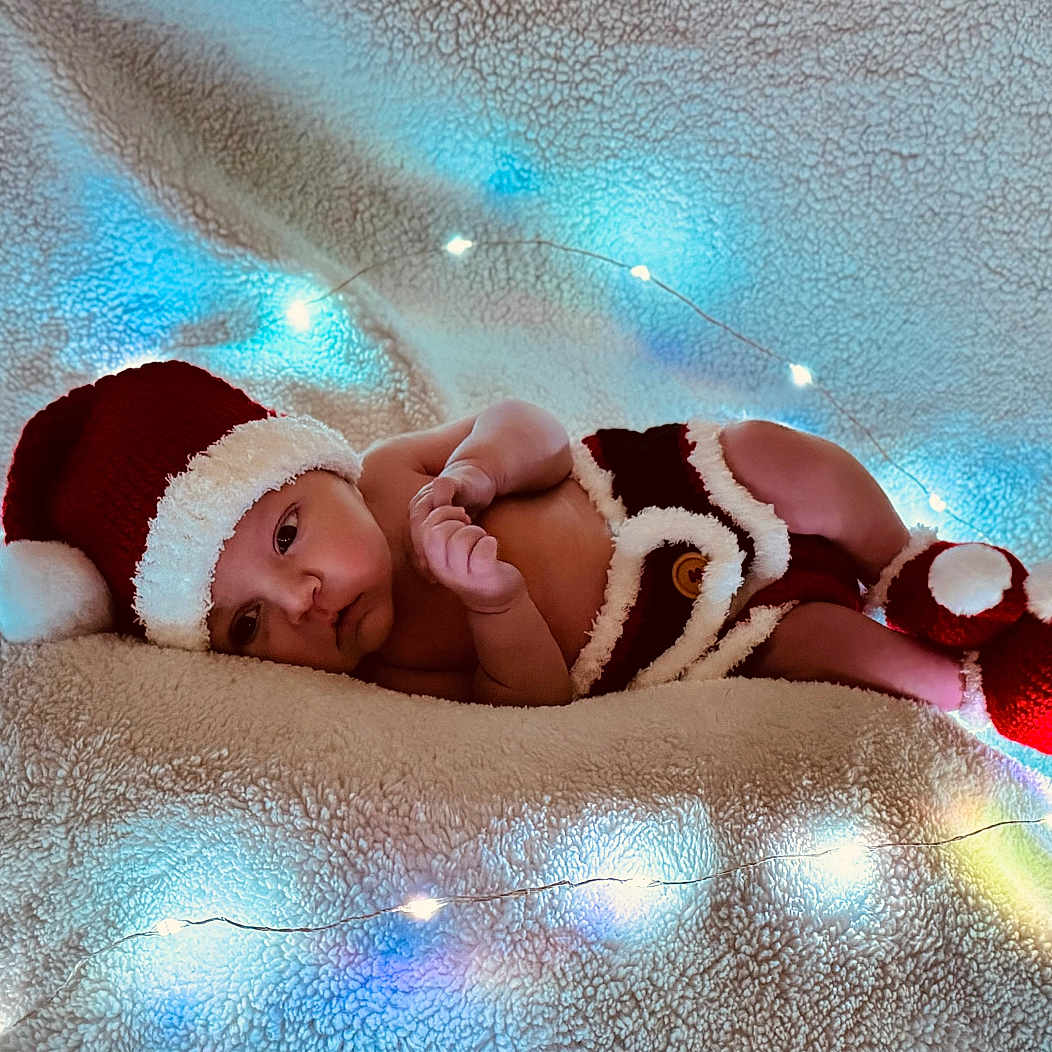 Weston is registered to the contest to win money with this photo: baby, ball, bodypart, bonnet, cap, clothing, cricket, cricketball, face, finger, hand, happy, hat, head, newborn, person, photography, portrait, smile, sport