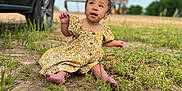 Nyomi joined the competition — help win amazing prizes! baby, barefoot, casual, child, curious, daylight, dirt, field, grass, nature, outdoor, people, portrait, sitting, sunny, suv, toddler, vehicle, yellow_dress, young_child