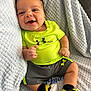 baby, infant, smiling, happy, clothing, neon_green, shorts, sneakers, black_socks, blanket, texture, soft, indoor, portrait, cute, child, person, face, hand, feet