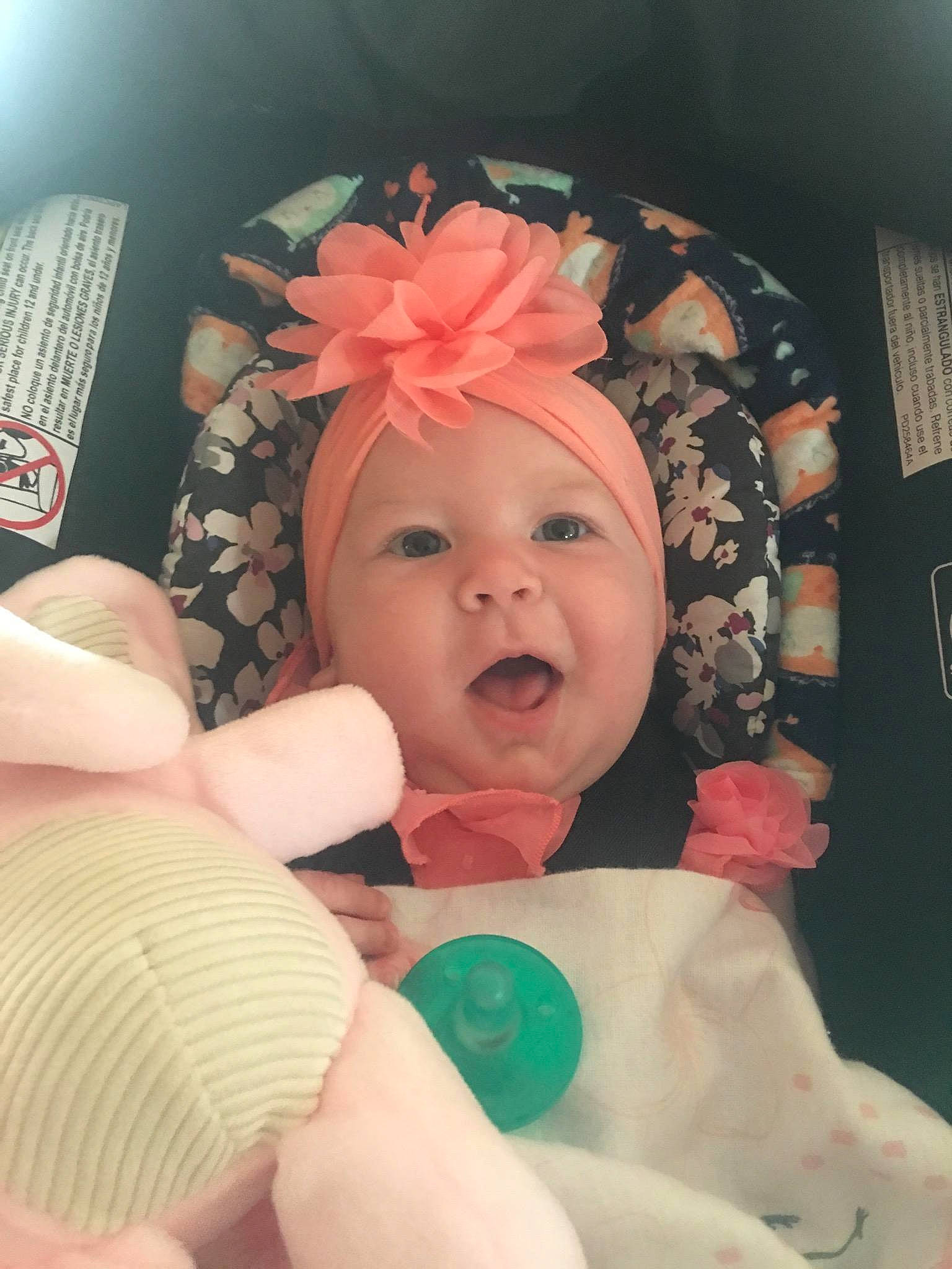 Brenlee is registered to the contest to win money with this photo: baby, birth, cheek, child, ear, eye, face, facial_expression, finger, hair_accessory, hand, head, headgear, mouth, person, photography, pink, skin, smile, thumb