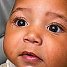 baby, child, face, close_up, eyes, eyelashes, skin, cheeks, mouth, nose, yellow_clothing, infant, portrait, cute, innocence, expression, human, young, adorable, soft_light