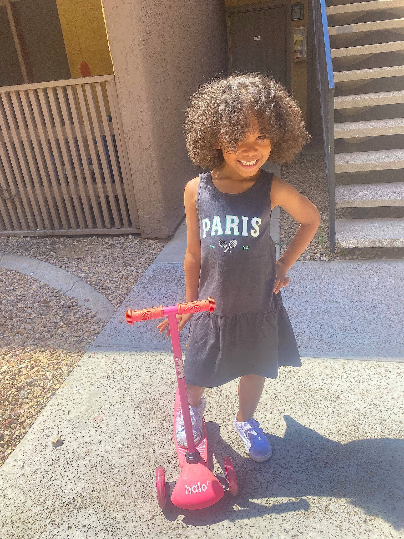 Layah joined the competition — help win amazing prizes! asphalt, child, door, driveway, electric_blue, fun, grass, human_leg, joy, kick_scooter, knee, person, recreation, road_surface, rolling, sandal, shorts, sidewalk, smile, tire