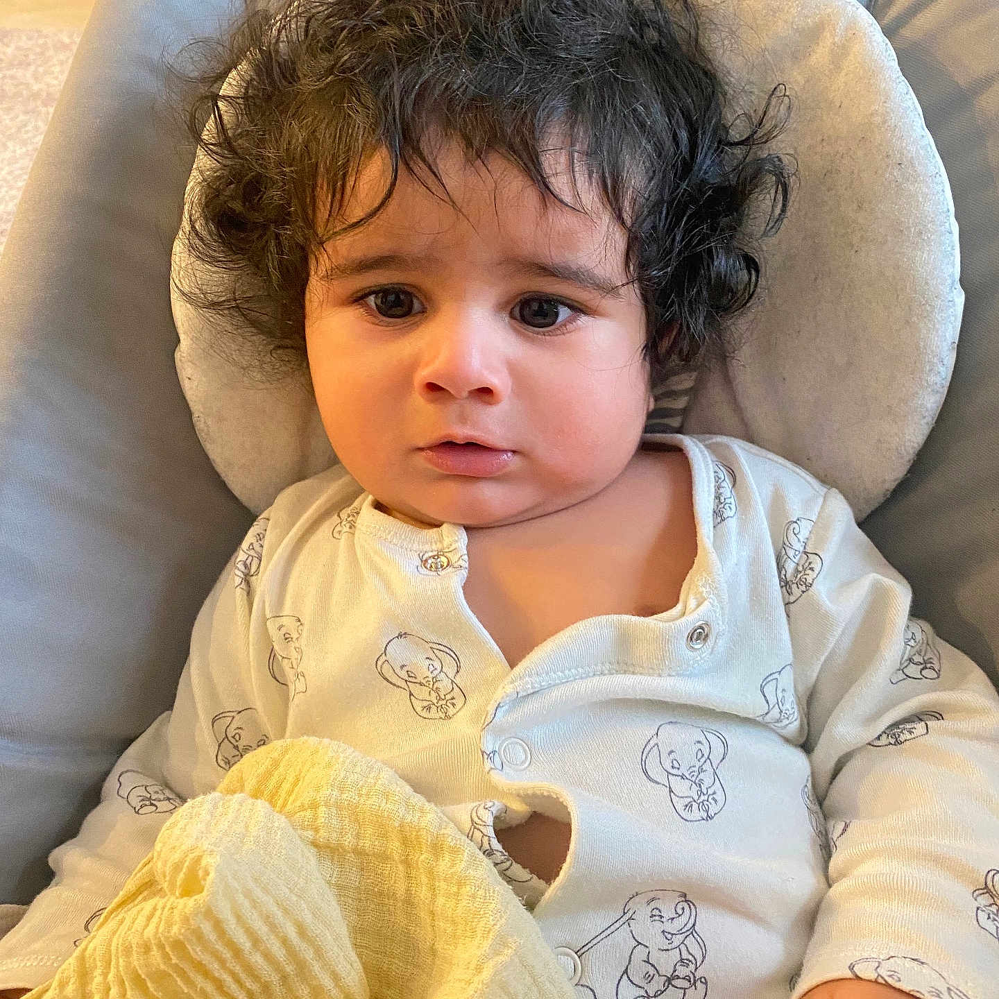 Manvir is registered to the contest to win money with this photo: baby, blackhair, blanket, brownhair, clothing, curlyhair, cushion, face, frown, hair, head, homedecor, person, photography, portrait, sad, sleeve, wig