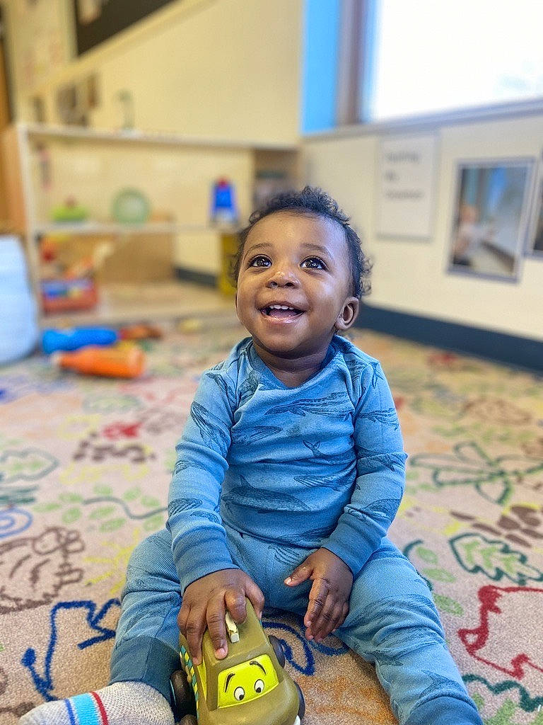 Juelz Smith is registered to the contest to win money with this photo: baby, baby_toddler_clothing, cheek, child, floor, flooring, fun, happy, hardwood, joy, leisure, person, photograph, play, room, sitting, skin, smile, snapshot, toddler