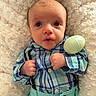 Reuben is registered to the contest to win money with this photo: baby, infant, plaid_shirt, mint_green_pants, pastel_egg, fluffy_blanket, curious_expression, cute, hands_clenched, lying_down, soft_texture, indoor, portrait, child, young_baby, blue, green, comfortable, cozy, adorable