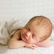 Reuben is registered to the contest to win money with this photo: baby, newborn, sleeping, infant, blanket, bedding, portrait, face, head, hands, cheeks, soft_light, closeup, peaceful, skin, hair, resting, studio_photography, cozy, texture