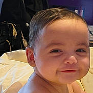 Ramey is registered to the contest to win money with this photo: baby, background, blanket, candid, child, cute, expression, face, hair, happy, head, indoors, person, portrait, shoulders, sitting, skin, smile, soft, young