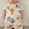 baby, infant, child, face, overalls, clothing, winnie_the_pooh, tigger, eeyore, piglet, footwear, barefoot, lying_down, portrait, cute, indoors, soft_surface, expression, baby_clothes, colorful