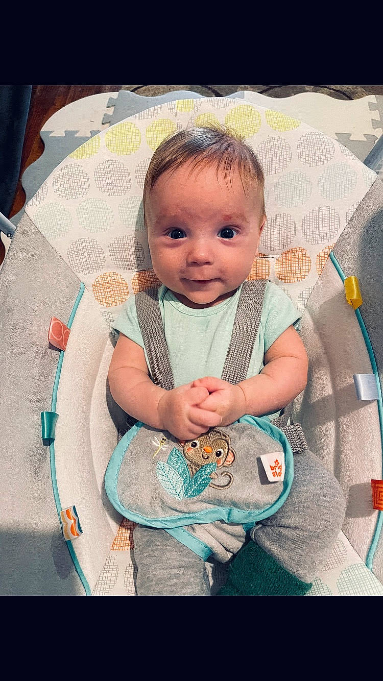 Jason is registered to the contest to win money with this photo: baby, baby_carriage, baby_products, baby_toddler_clothing, cheek, child, eye, eyelash, face, happy, head, iris, linens, pattern, person, pink, product, skin, sleeve, smile