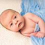 baby, infant, blue_cloth, blanket, lying_down, skin, face, eyes, expression, cute, newborn, child, soft_texture, hand, portrait, closeup, sleepwear, resting, indoors, peaceful