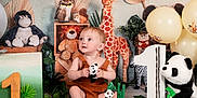 Rían Colby is registered to the contest to win money with this photo: baby, child, birthday, cake, panda, stuffed_animal, giraffe, balloon, decorations, jungle_theme, toy, owl, lion, monkey, zebra, number_one, green, white, celebration, party