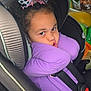 Amiyah joined the competition — help win amazing prizes! child, car_seat, purple_shirt, bow, curly_hair, car_interior, seatbelt, snacks, playful, pout, young, cute, safety, travel, seat, child_safety, interior, seat_belt, person, casual