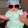 accessory, baby, bucket_hat, child, clothing, cute, face, fashion, hand, headwear, indoor, infant, mint_green, overalls, person, portrait, posing, skin, sunglasses, young