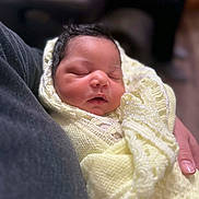 Elliana is registered to the contest to win money with this photo: baby, newborn, sleeping, blanket, knitted, soft, wrapped, infant, cute, peaceful, closeup, portrait, person, hand, warm, cozy, indoors, child, resting, tender
