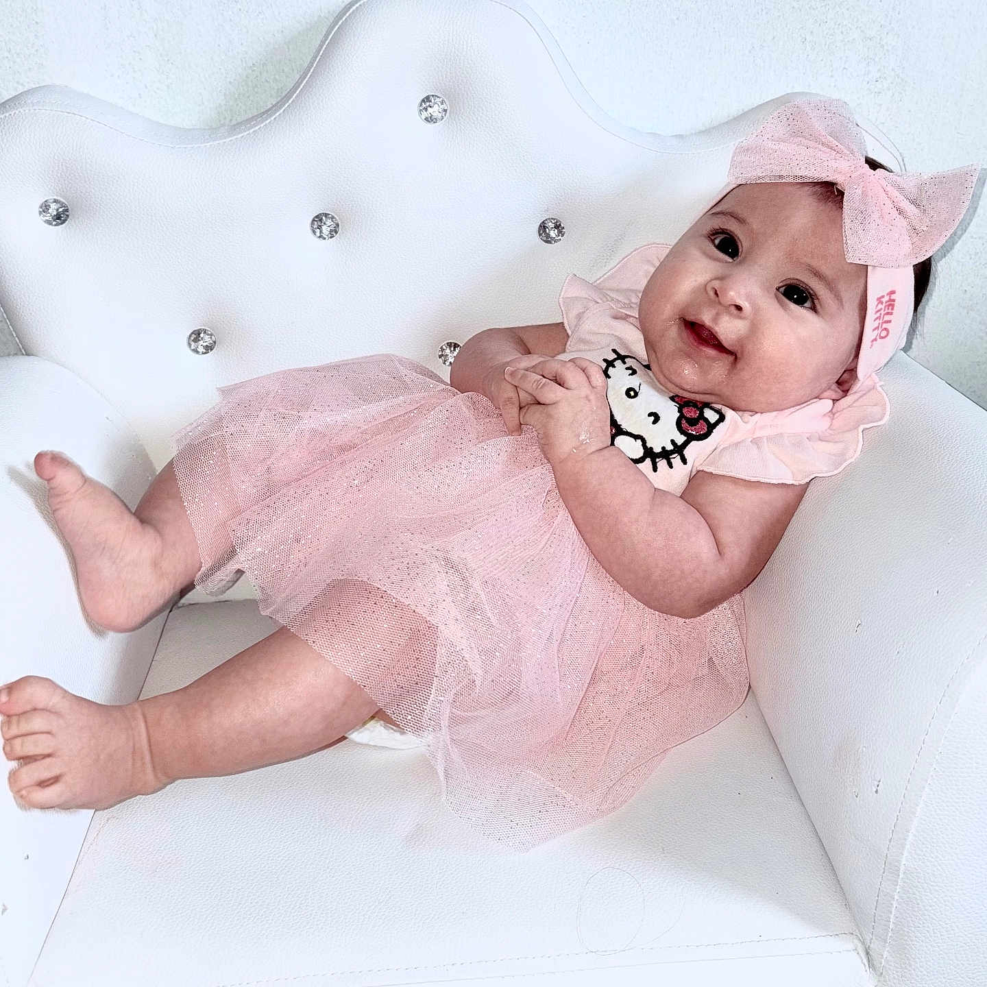Mía Alessandra joined the competition — help win amazing prizes! adorable, baby, bow, child, cute, fashion, happy, headband, indoor, infant, person, pink_dress, portrait, sitting, smiling, soft_lighting, sparkly, tutu, white_chair, young