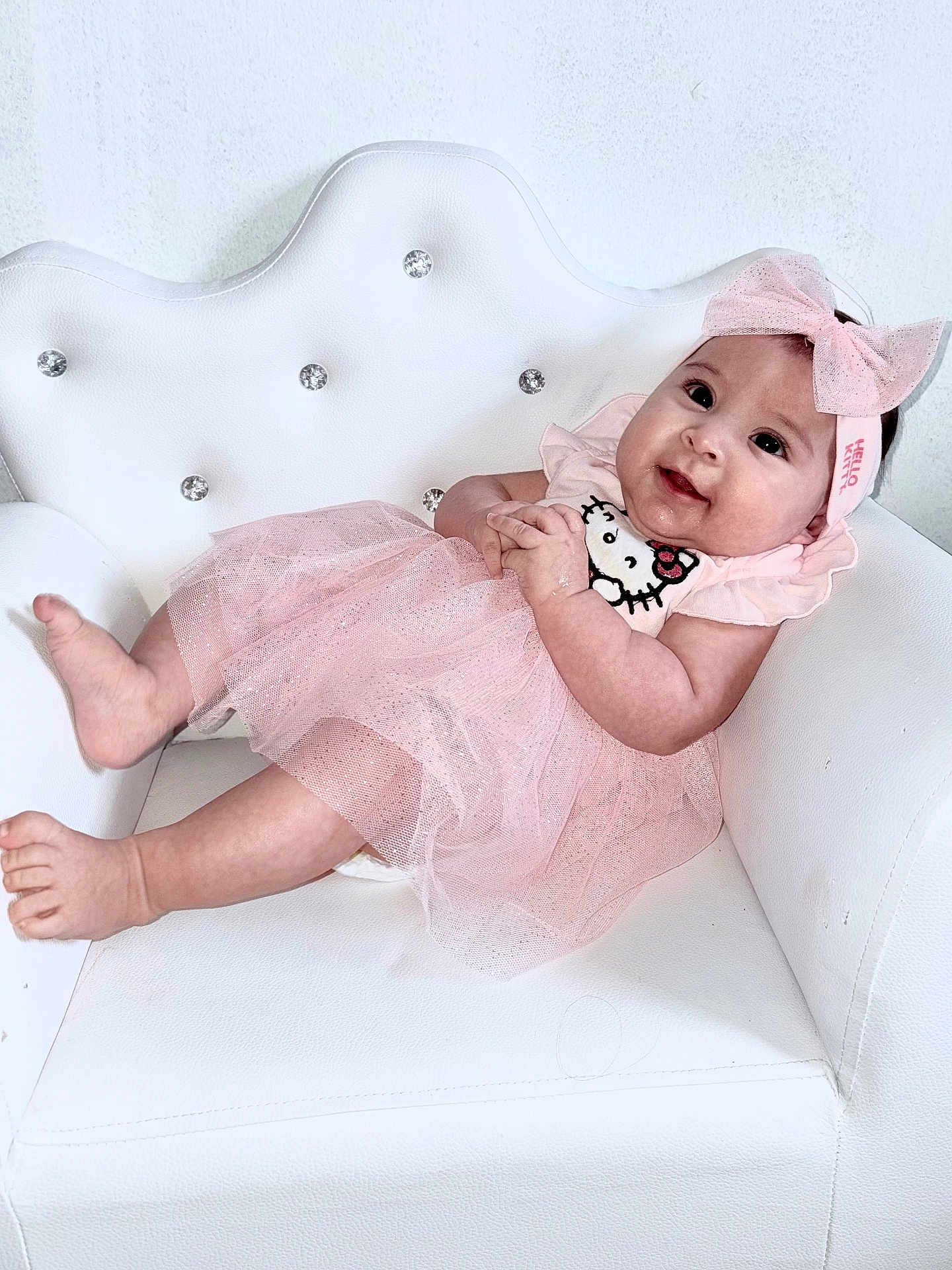 Mía Alessandra joined the competition — help win amazing prizes! baby, infant, pink_dress, headband, bow, sparkly, white_chair, smiling, cute, child, tutu, sitting, portrait, happy, indoor, person, young, adorable, soft_lighting, fashion