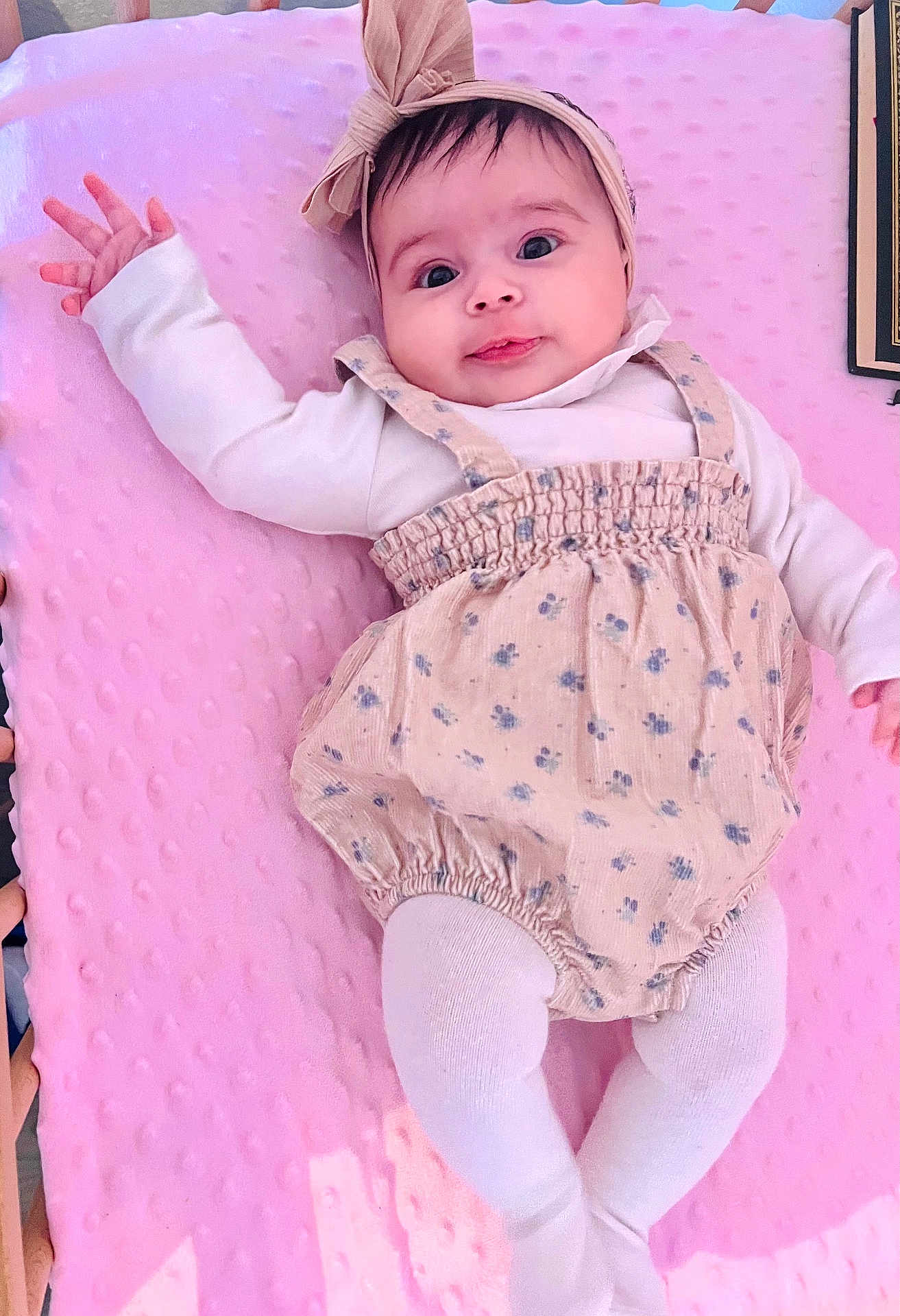 Ayla participe au concours pour gagner de l'argent avec cette photo : baby, infant, child, pink_blanket, romper, headband, bow, tights, cute, playful, lying_down, indoors, soft_texture, clothing, portrait, smiling, person, hands, face, wide_eyes