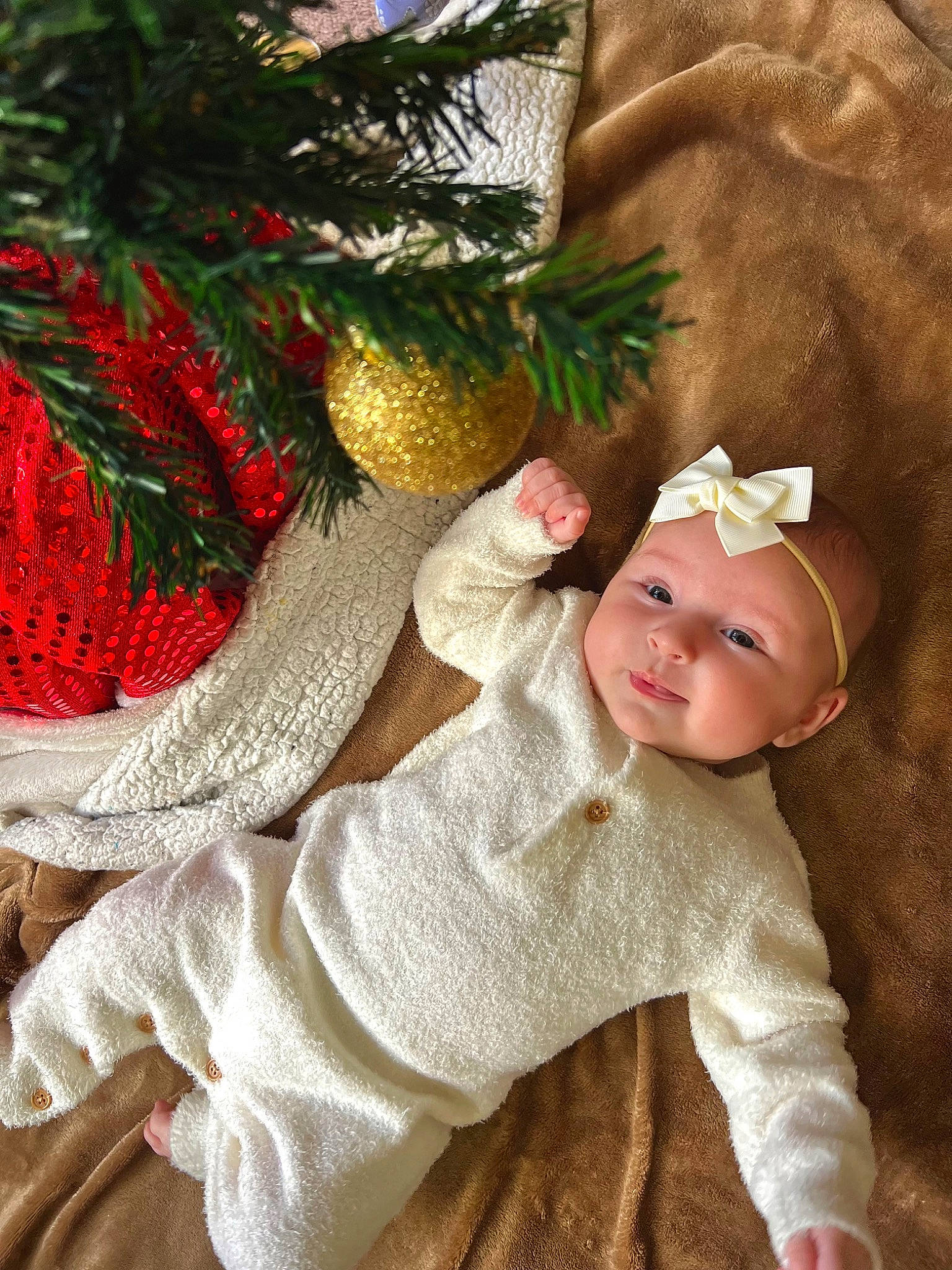 Nevada is registered to the contest to win money with this photo: baby, baby_toddler_clothing, christmas_decoration, christmas_ornament, costume_hat, event, evergreen, fawn, grass, happy, headgear, headwear, holiday_ornament, human_body, ornament, people_in_nature, person, plant, smile, toddler