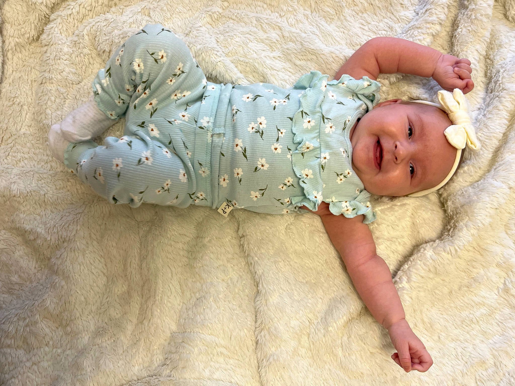 Nevada is registered to the contest to win money with this photo: baby, baby_products, baby_sleeping, baby_toddler_clothing, child, comfort, flooring, foot, grass, head, headwear, human_body, linens, nap, pattern, person, sitting, sleep, sleeve, sock