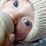 Eddy a rejoint le concours — aidez-le/la à gagner de superbes lots ! baby, blue_eyes, bottle, feeding, hand, knitted_hat, close_up, face, infant, skin, nail, warm_clothing, cozy, portrait, newborn, cute, child, soft_texture, candid, intimate