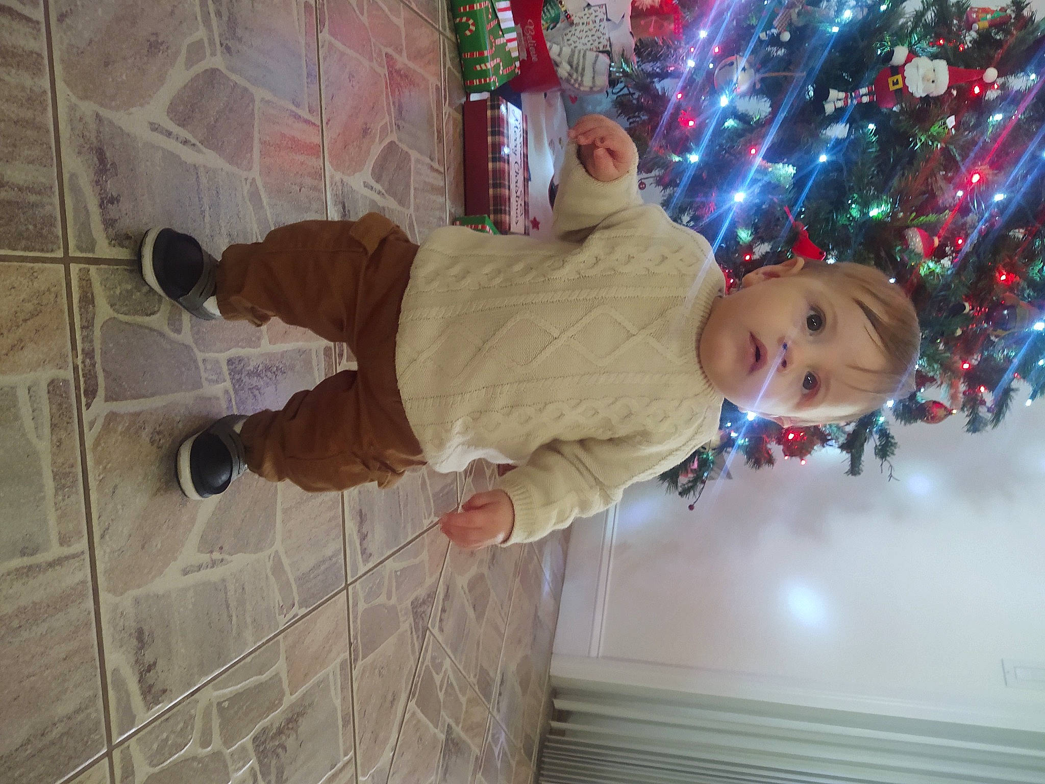 Matias joined the competition — help win amazing prizes! baby_toddler_clothing, child, christmas, christmas_decoration, christmas_eve, christmas_ornament, christmas_tree, event, flooring, fun, happy, holiday, ornament, pattern, person, plant, room, smile, toddler, tree