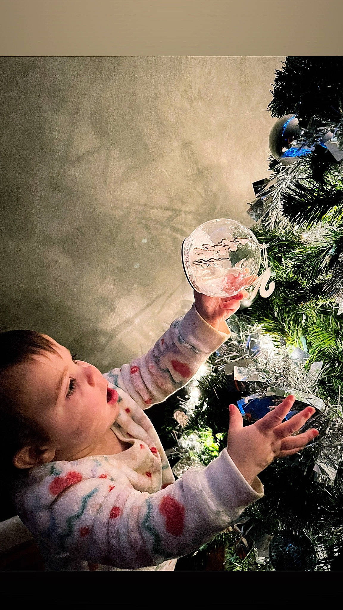 Arya is registered to the contest to win money with this photo: baby, child, christmas_decoration, christmas_ornament, christmas_tree, event, finger, flash_photography, fun, gesture, grass, hairstyle, happy, holiday_ornament, ornament, people_in_nature, person, plant, sitting, toddler