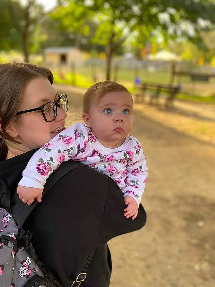 Natalie is registered to the contest to win money with this photo: baby, baby_toddler_clothing, child, event, eyewear, face, fun, glasses, grass, happy, iris, leisure, people_in_nature, person, plant, recreation, sitting, skin, sleeve, surprise