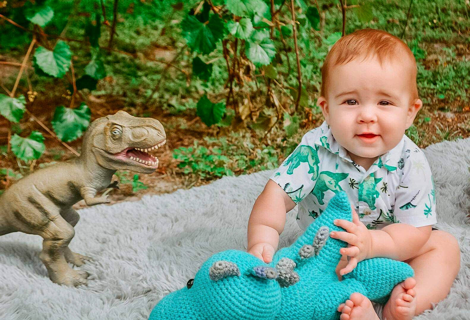 Waylon is registered to the contest to win money with this photo: baby_toddler_clothing, dinosaur, dress, eye, face, fawn, felidae, grass, green, hand, happy, mouth, people_in_nature, person, photograph, plant, terrestrial_animal, toddler, tree, vertebrate