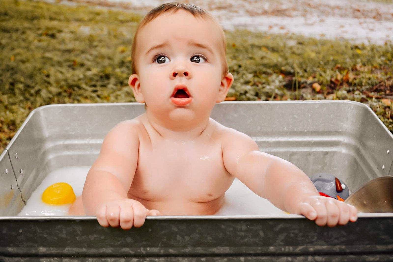 Waylon is registered to the contest to win money with this photo: baby, baby_bathing, baby_products, bathing, bathtub, cheek, child, face, fun, grass, happy, head, leisure, people, person, play, product, recreation, sitting, skin