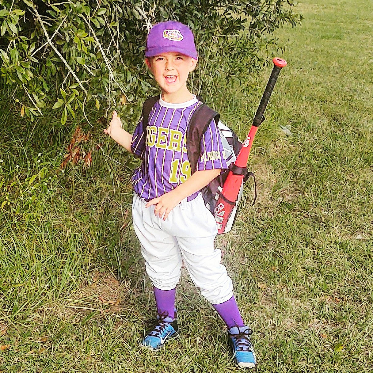 Reese is registered to the contest to win money with this photo: baseball_bat, baseball_cap, baseball_equipment, baseball_player, baseball_uniform, bat_and_ball_games, cap, child, grass, happy, headwear, joy, people_in_nature, person, plant, player, smile, sneakers, softball_bat, sports