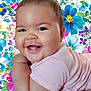 arm, baby, bright, cheeks, child, colorful, cute, eyes, face, floral_background, happy, infant, joy, lying_down, mouth, pink_clothing, portrait, skin, smiling, soft_skin