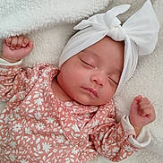 Heavanly is registered to the contest to win money with this photo: baby, sleeping, infant, headband, bow, floral_clothing, pink, white, blanket, soft, peaceful, closeup, portrait, cute, resting, newborn, child, face, hand, cozy