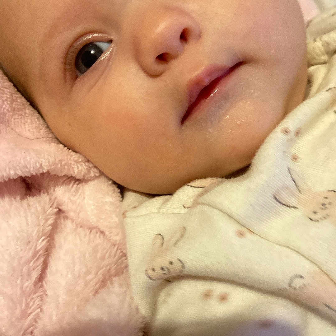 Shelbyrose joined the competition — help win amazing prizes! baby, blanket, child, closeup, comfort, cute, expression, face, head, indoors, infant, lying_down, newborn, onesie, pink, portrait, skin, sleepwear, soft, young